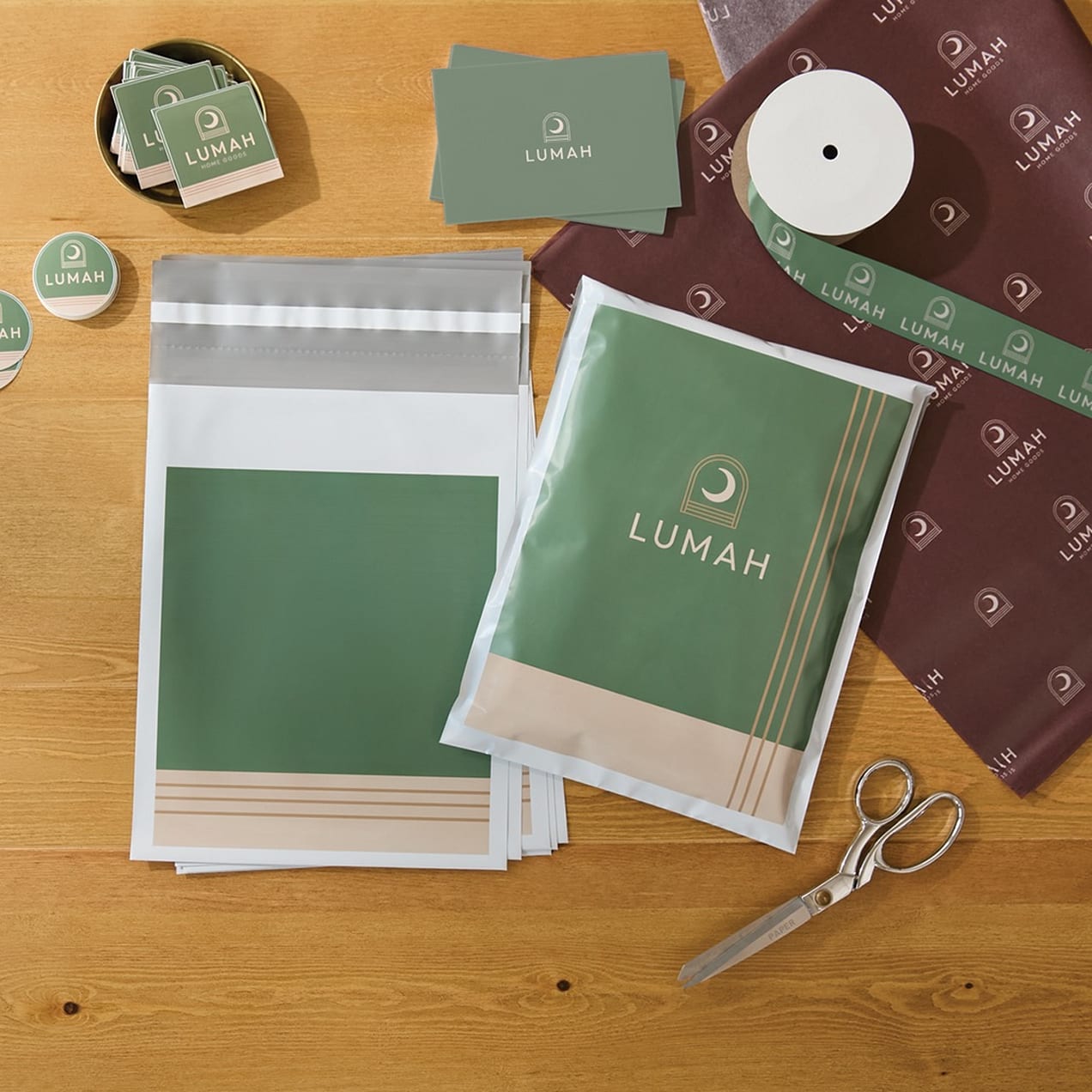 Branded poly-bag packaging, tape, stickers, and packing paper.