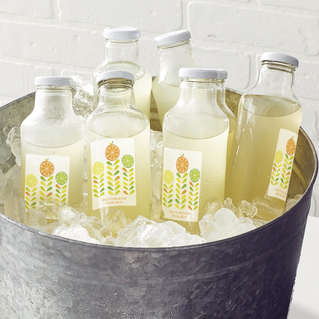 Glass bottles for drinks in an ice bucket.