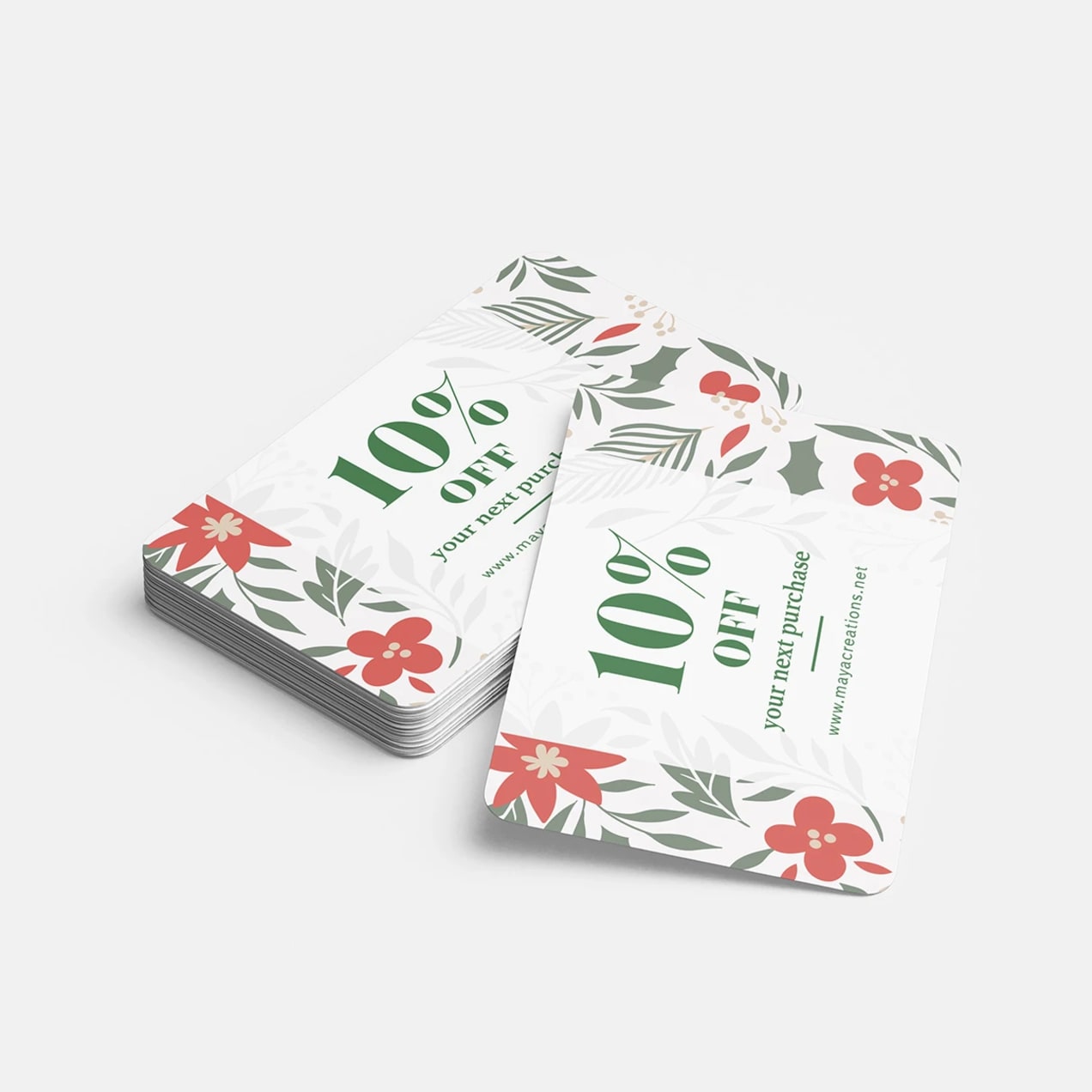 A stack of cards with a festive design offering 10% off next purchase