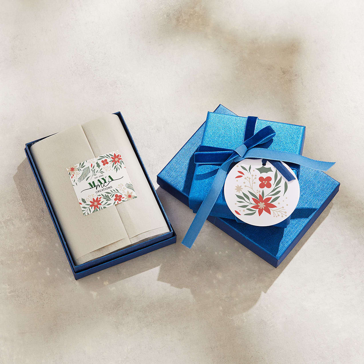 A gift-wrapped blue box with a branded sticker and festive tag