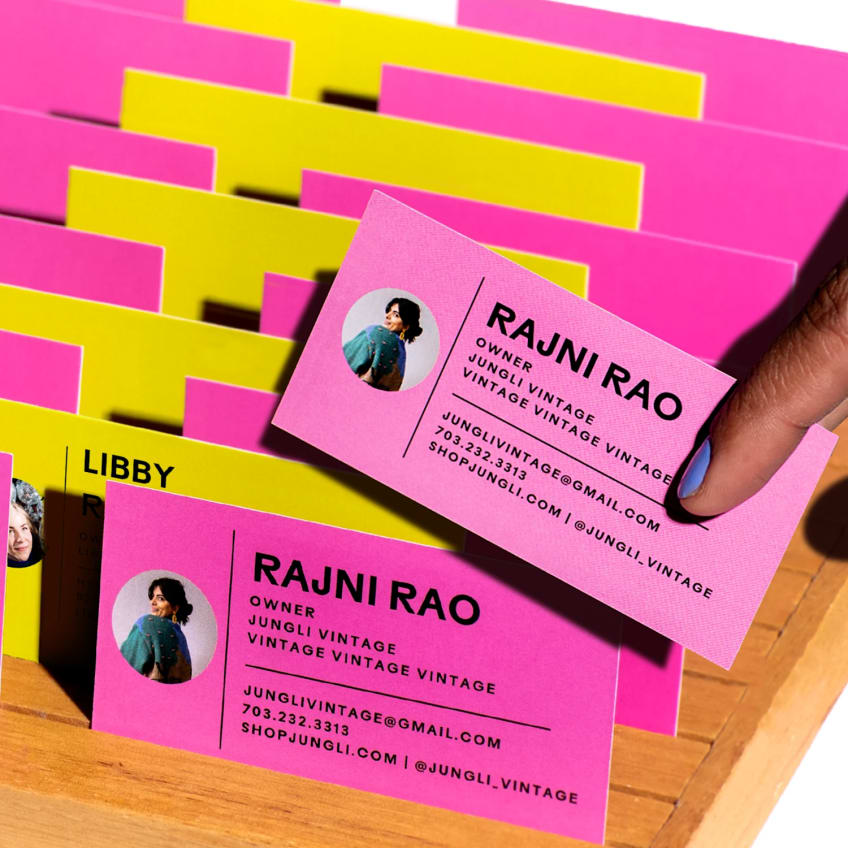Bright pink and yellow business cards for a vintage shop, featuring owner photos and contact details.