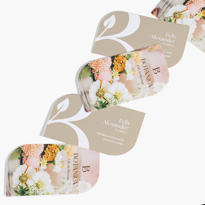 Die-cut florist business cards with rounded petal shapes and floral photography.