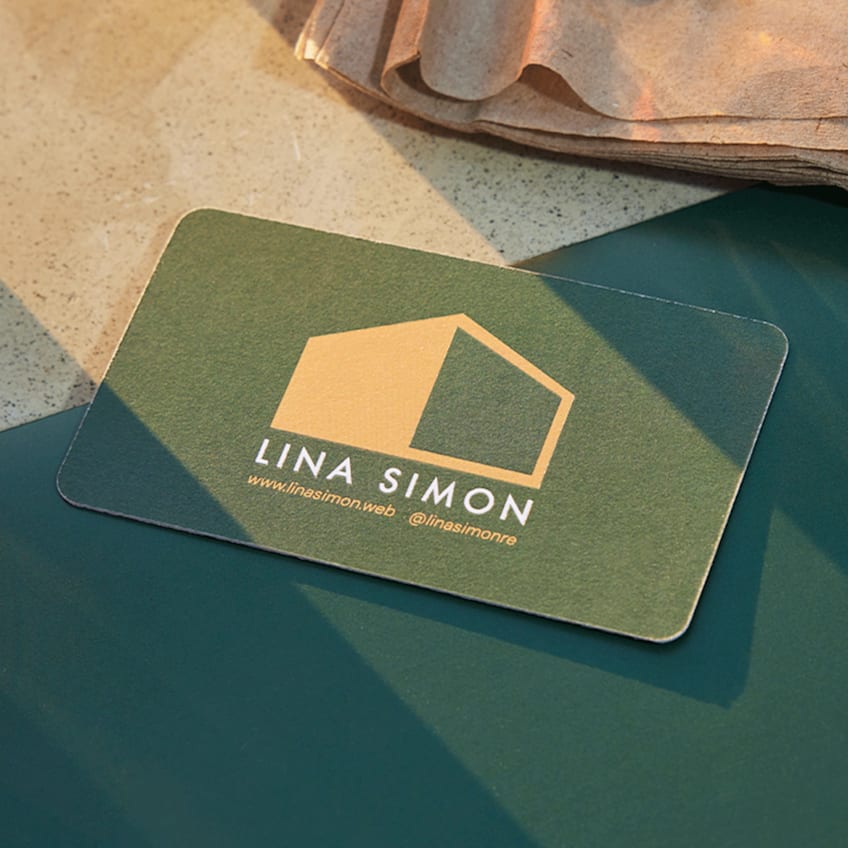 Green Lina Simon business card with a gold geometric house logo, website and Instagram handle.