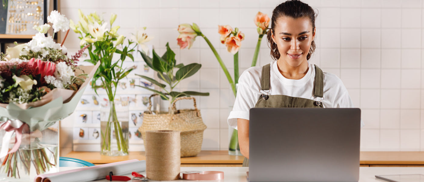shop owner typing on laptop