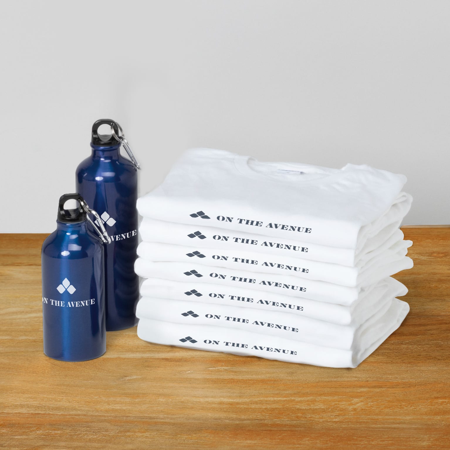 giveaway merch showing folded branded T shirts and emtal bottles