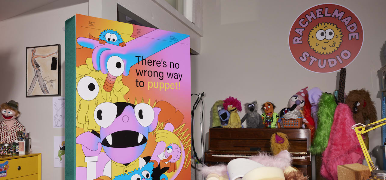 A colorful small business sign in a creative shop.