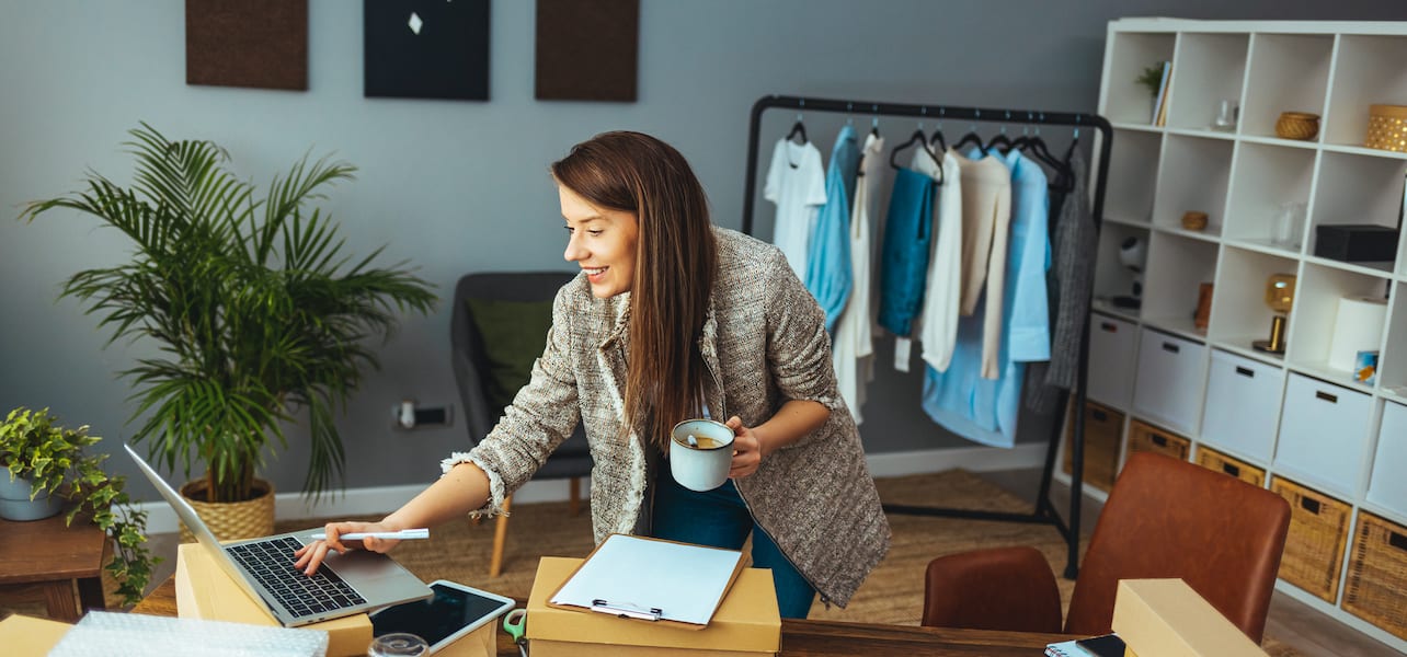 A woman business owner works on the computer in her office
