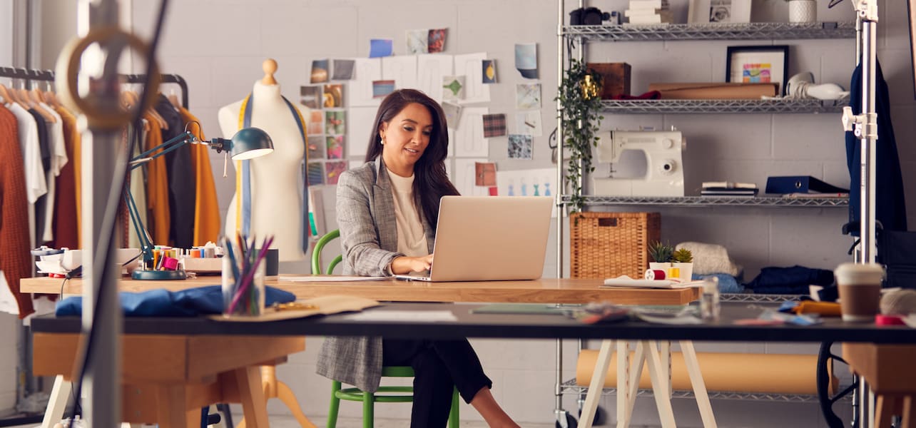 A small business owner reads Google reviews on a laptop
