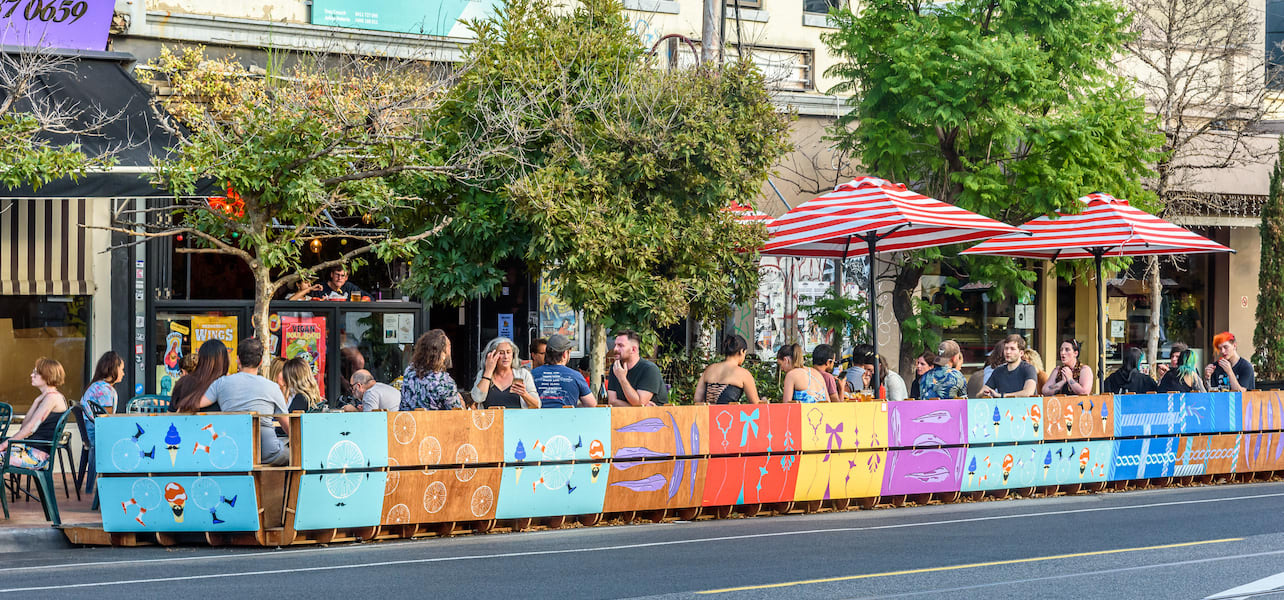 A colorful streatery on a city sidewalk.