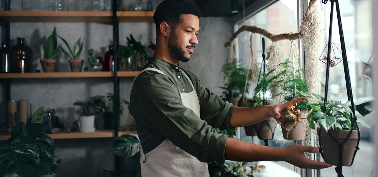 plant shop owner standing at shop window