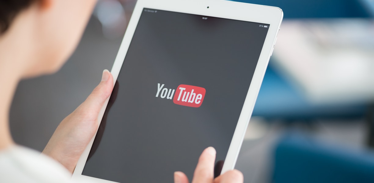 Woman opening YouTube on her tablet
