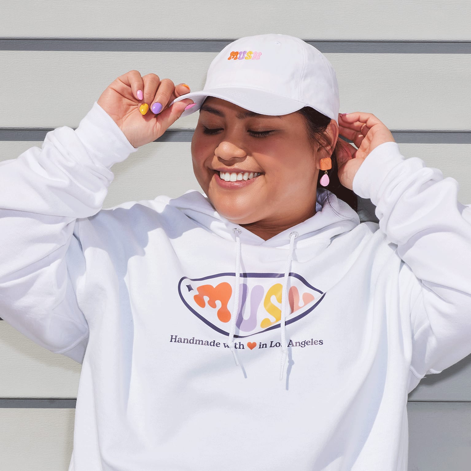 Woman wearing white custom cap and white hoodie
