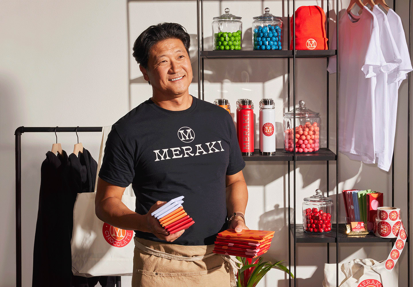 Vendor at a pop-up shop displaying branded products and promotional items in a well-organized booth setup