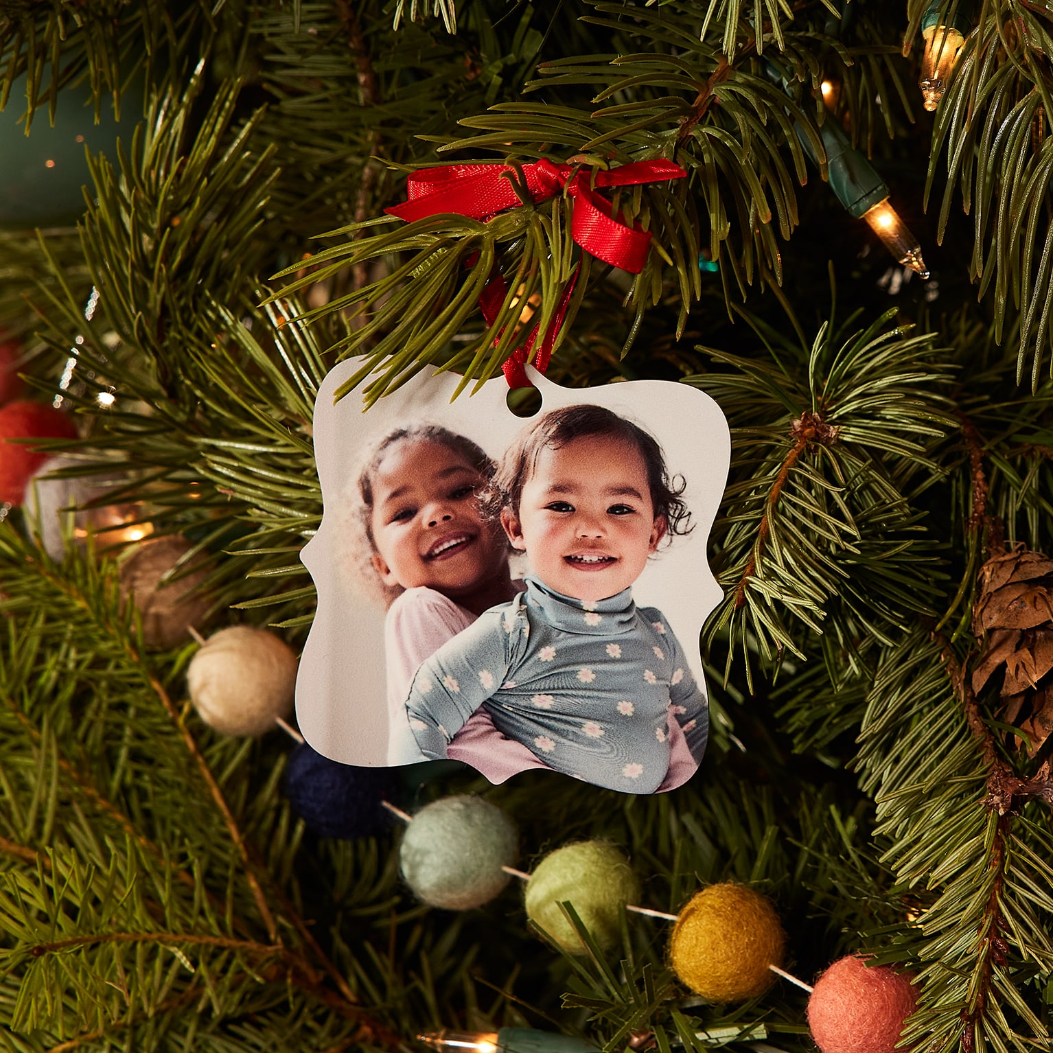Baubles with prints of kids onit on Christmas tree