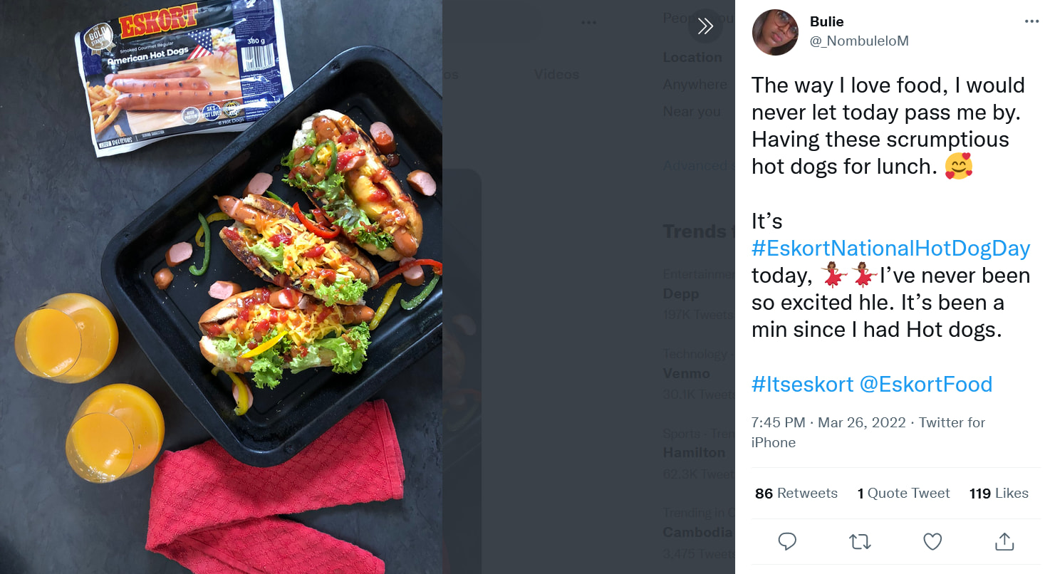 Three hotdog sandwiches in a black tray