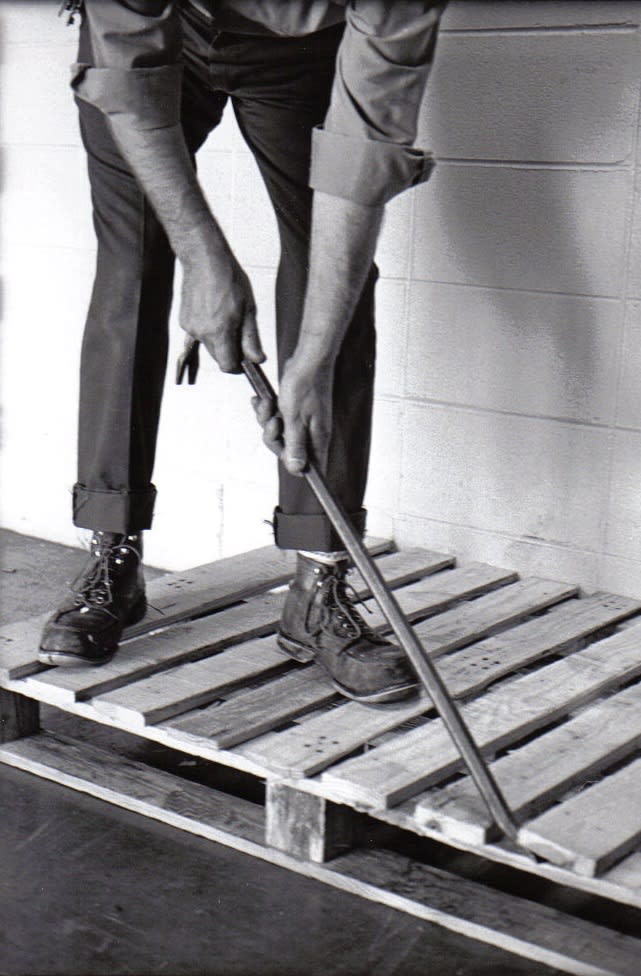 man deconstructs with a crowbar