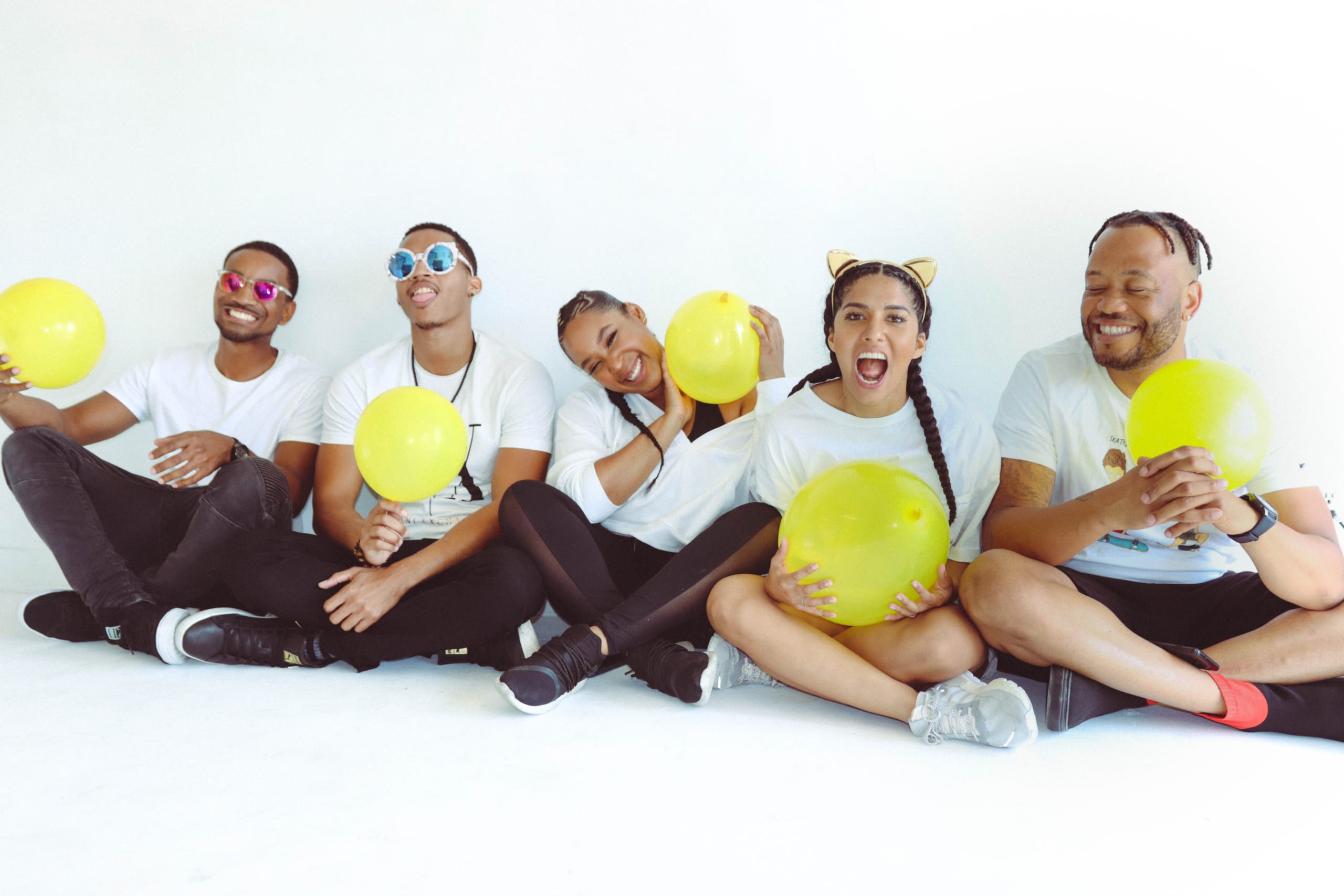 Breana Marin and the Love Pulse Music team holding yellow balloons