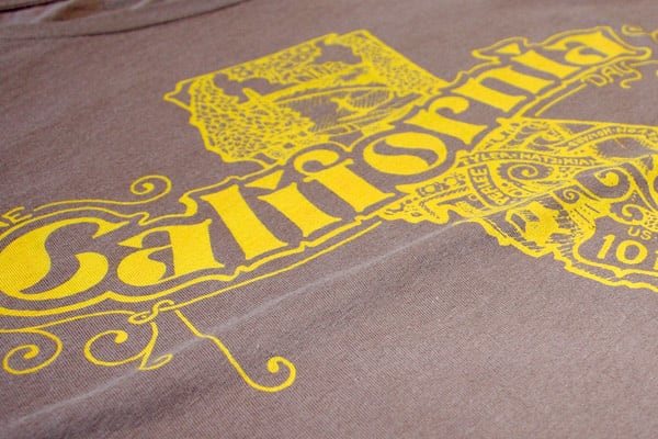 Example of screen printing a yellow design onto a beige T-shirt