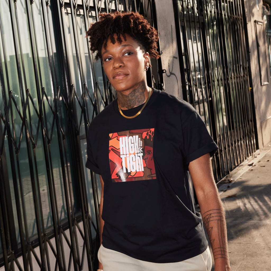 A person with a custom T-shirt design for High and Tight business