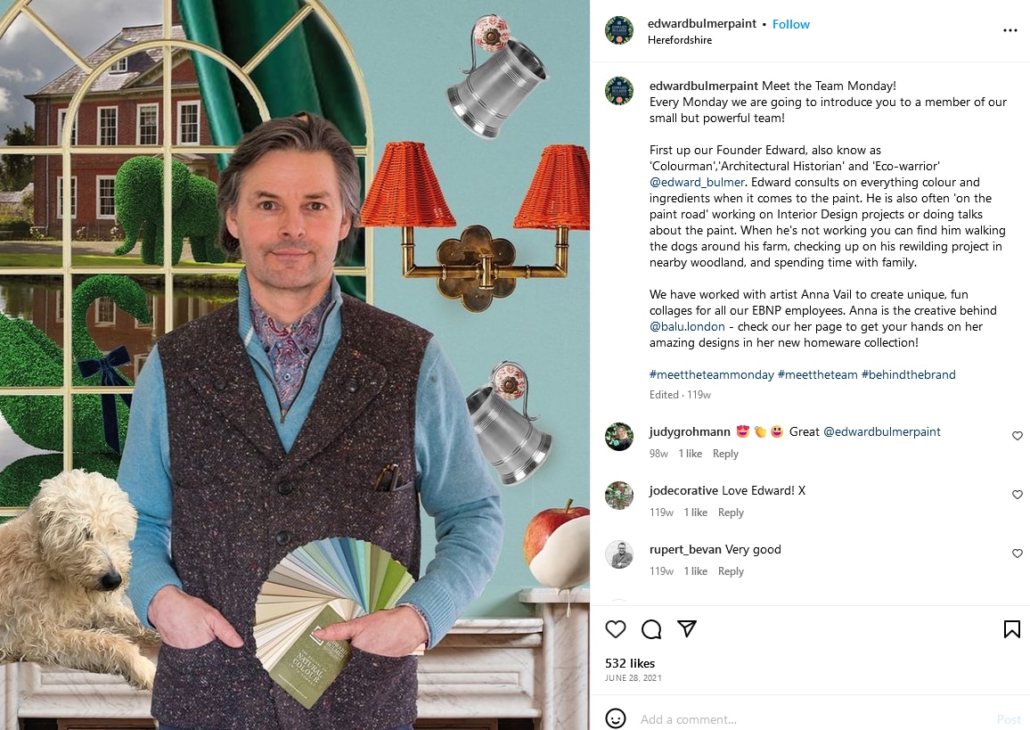 A man holding a set of paint swatches poses for a photo