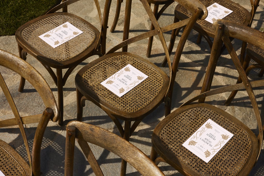 seats with a customized wedding program placed on each