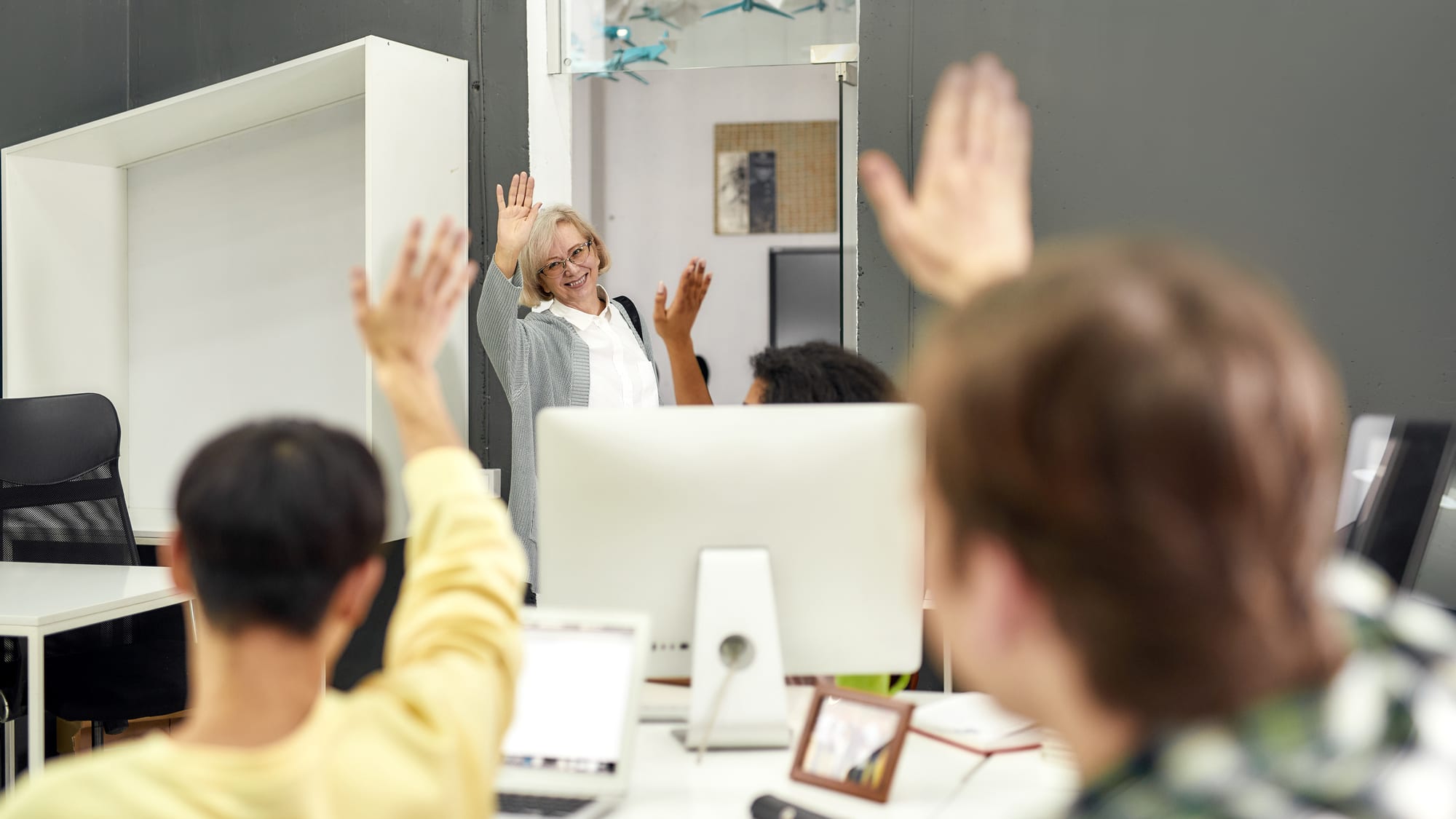 Cheerful woman saying farewell to colleagues