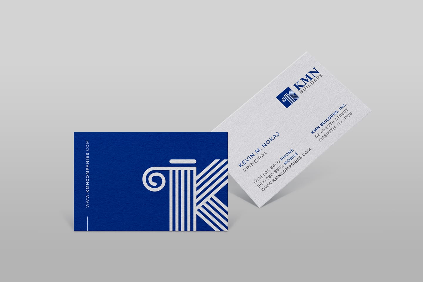 Blue and white business card with logo off the edge