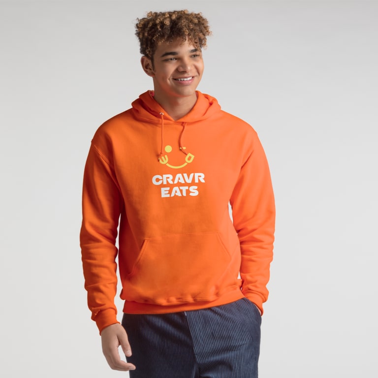 A person wearing an orange branded hoodie