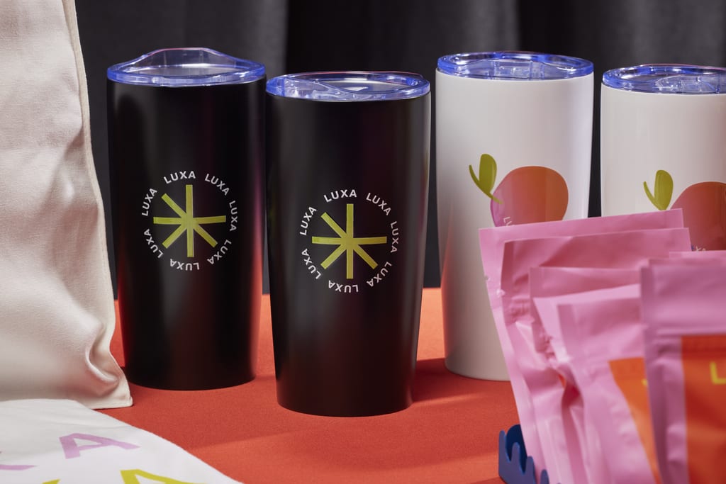 Branded tumblers at a trade show booth