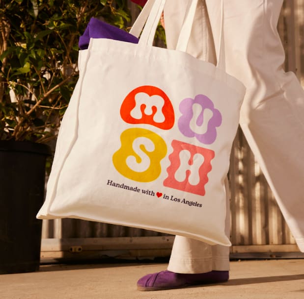 A tote bag with a bright brand logo print