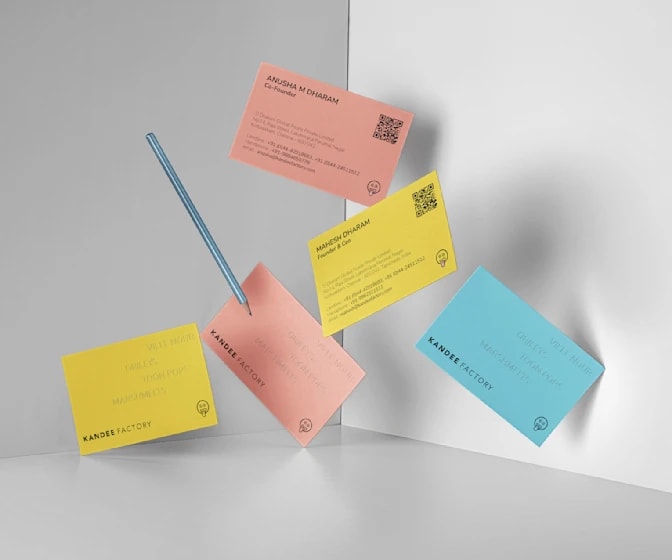 A selection of multi-colored business cards with a QR code in the business card layout