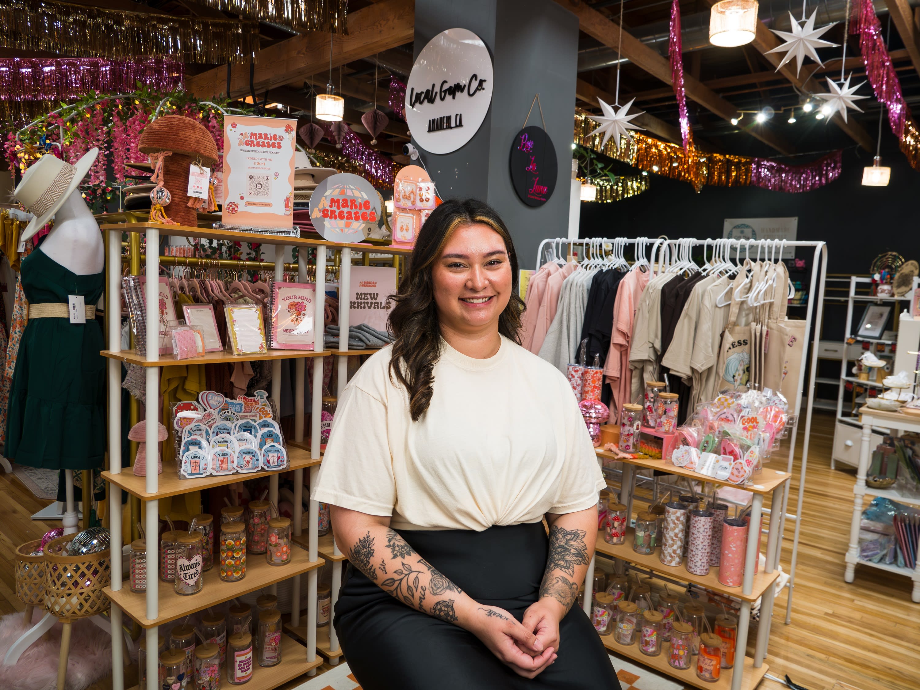 Owner of amariacreates sitting in front of her products.