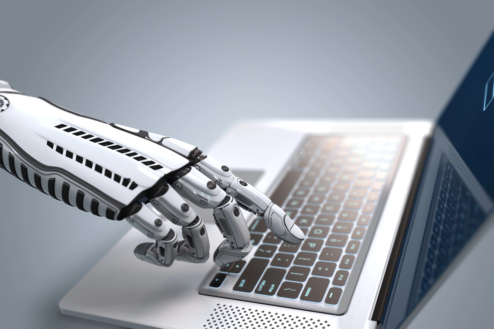 Robot hand using laptop.