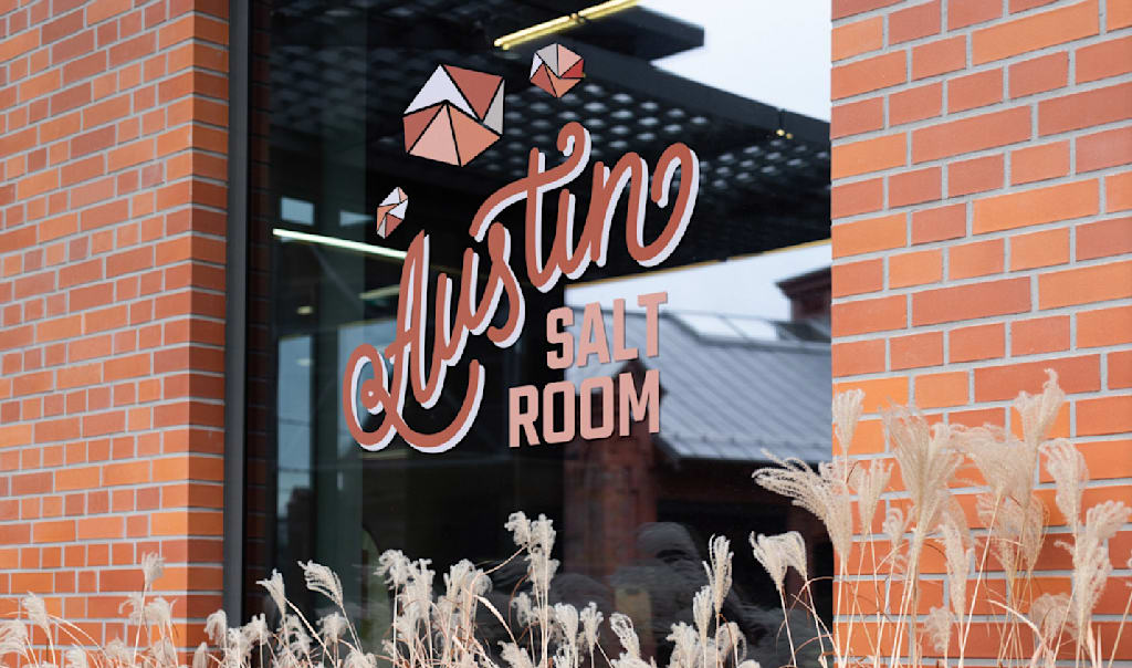 A business window sign using a mix of decorative and bold sans serif fonts