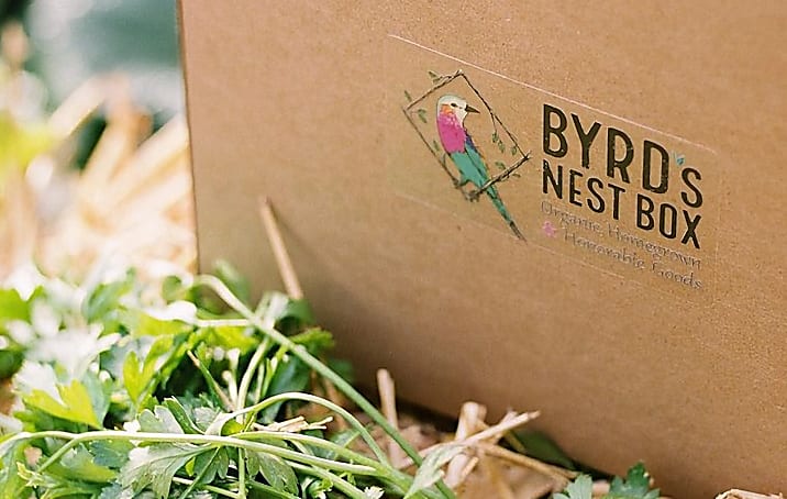 A packaging box branded with the company's logo sticker