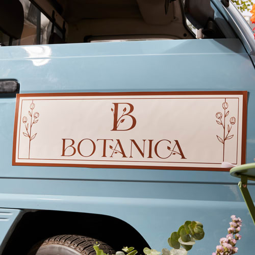 Classic logo design with flourishes printed on a car decal