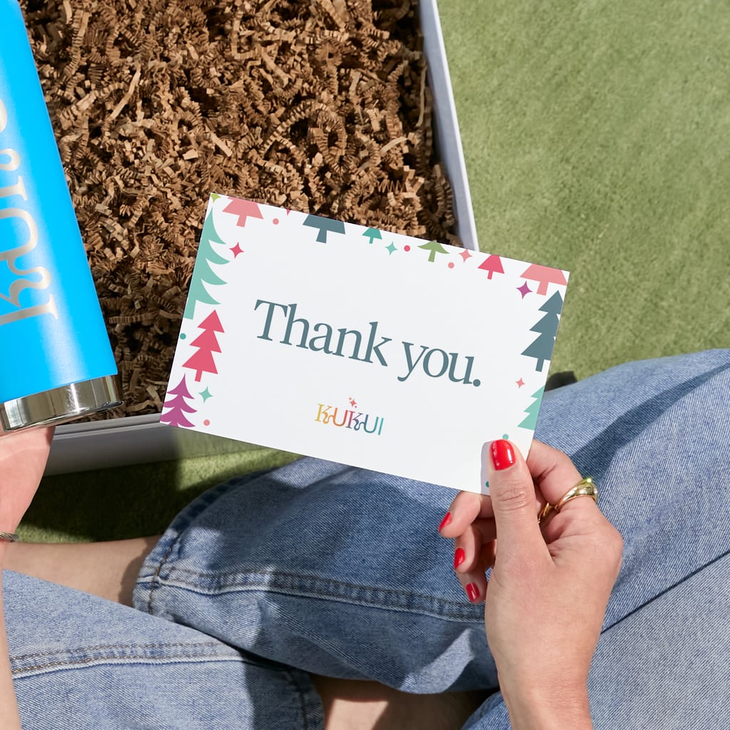 Hand holding a personalized "thank you" note