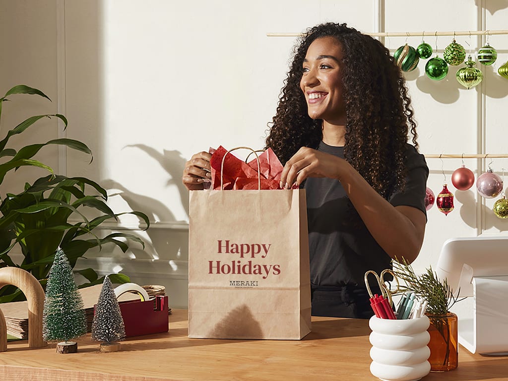 Woman filling a brown paper shopping bag on Black Friday.