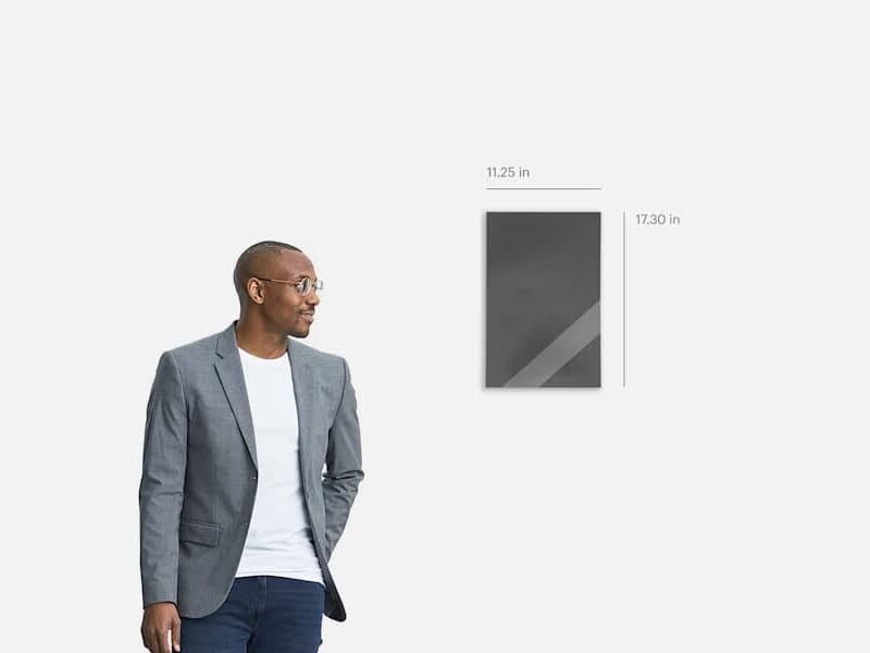 A poster calendar with its measurements, next to a person for comparison