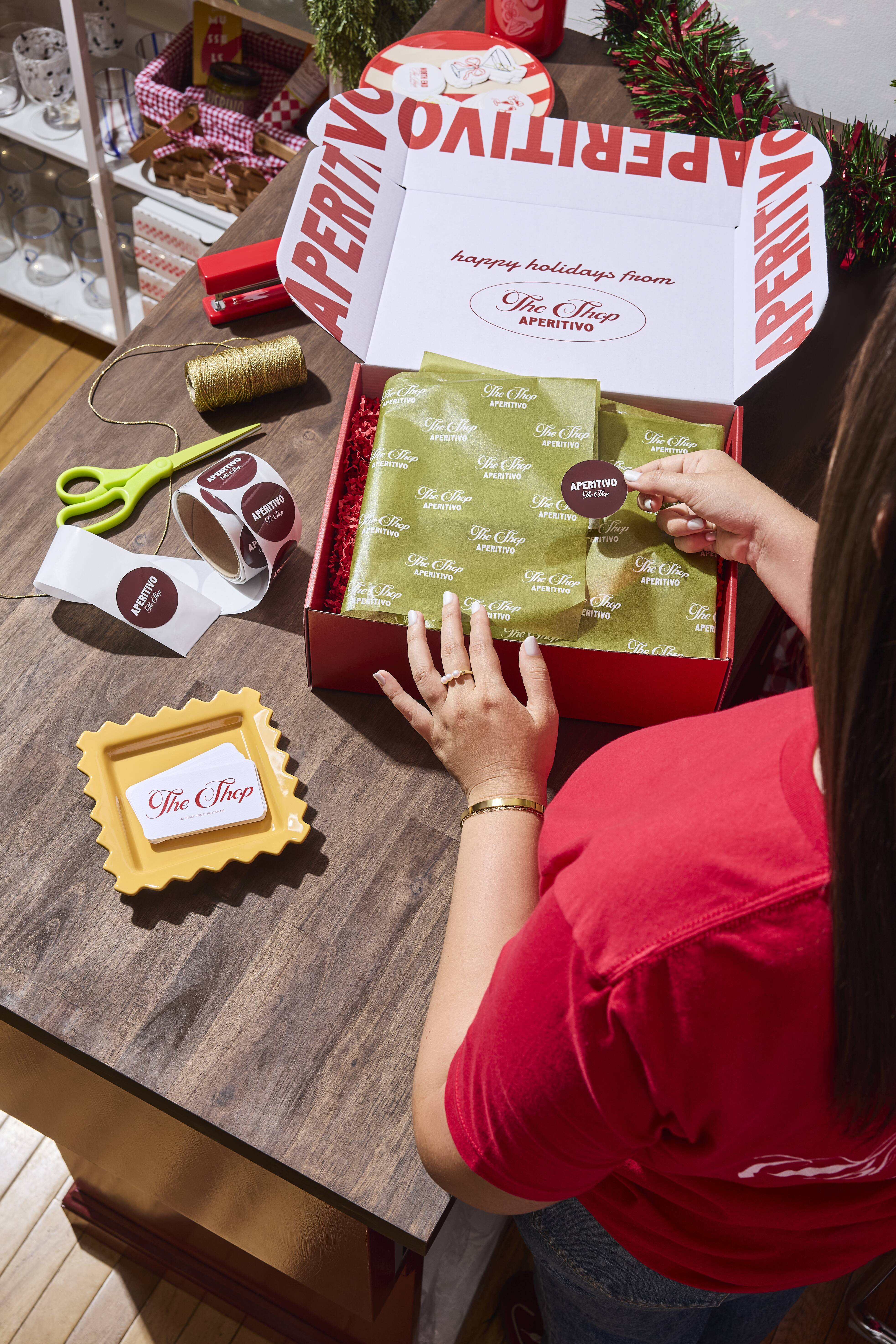 Woman using branded Aperitivo packaging.