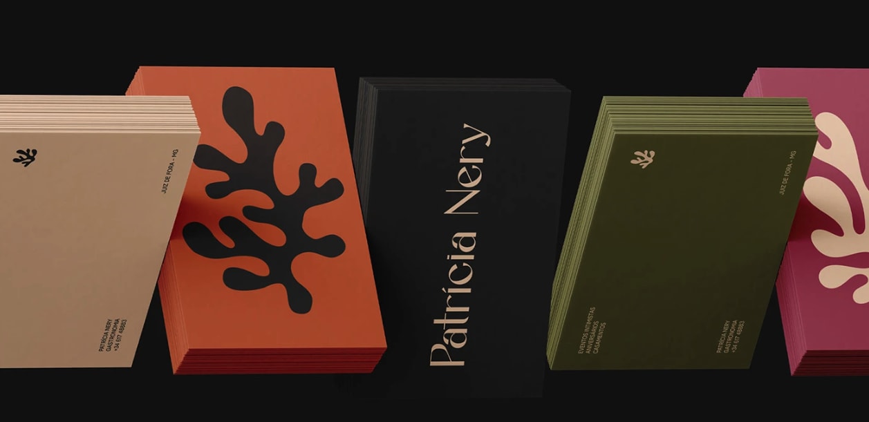 Set of different colored business cards in warm tones of orange, green, black and pink