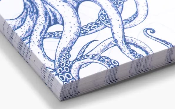 A white business card featuring a blue illustration of octopus tentacles made from recycled matte card