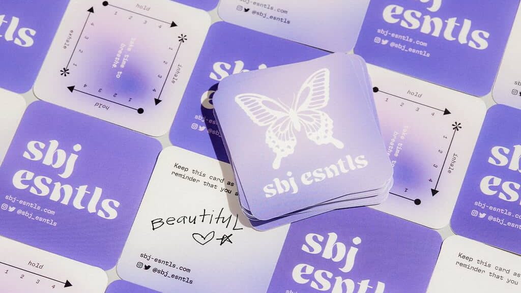 A stack of square business cards with the brand’s logo and name