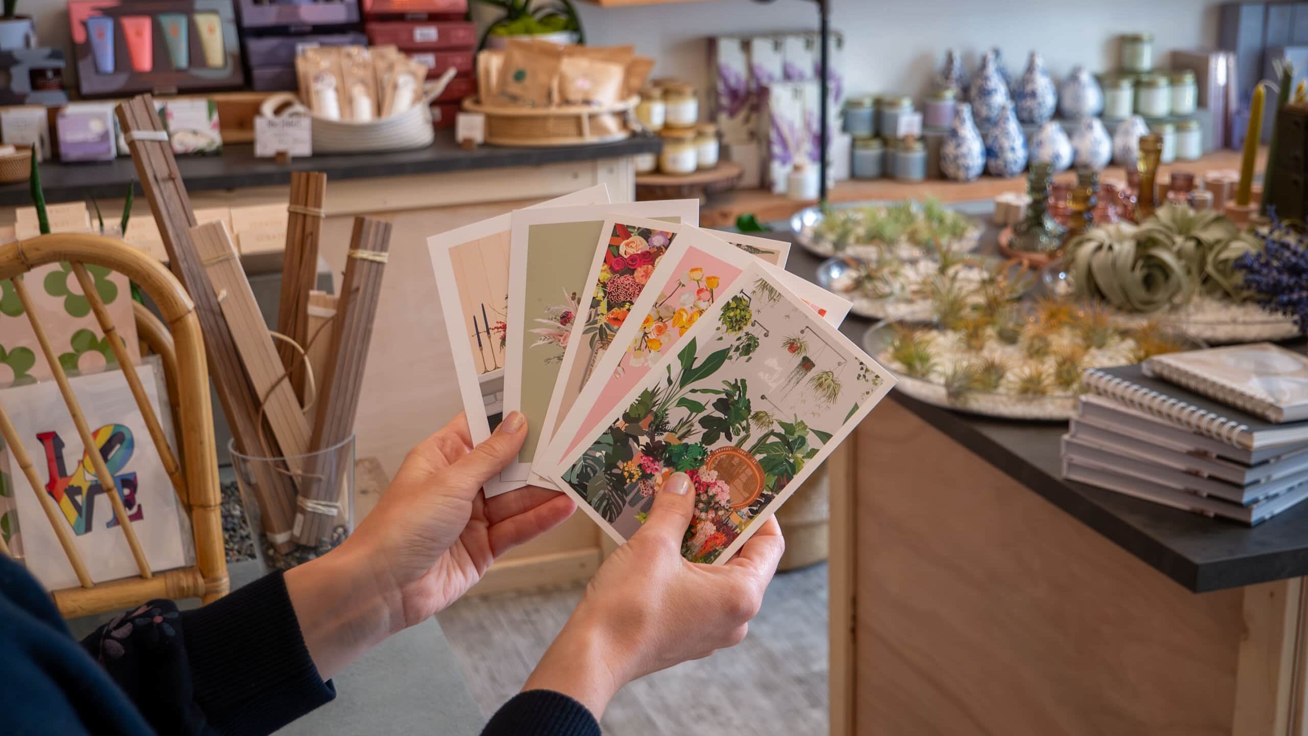 A selection of printed cards with the photos of flower arrangements for WildFlora print marketing