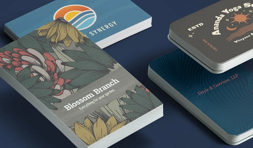 Stack of business cards in various styles featuring serif, sans-serif and script fonts with diverse layouts and textures