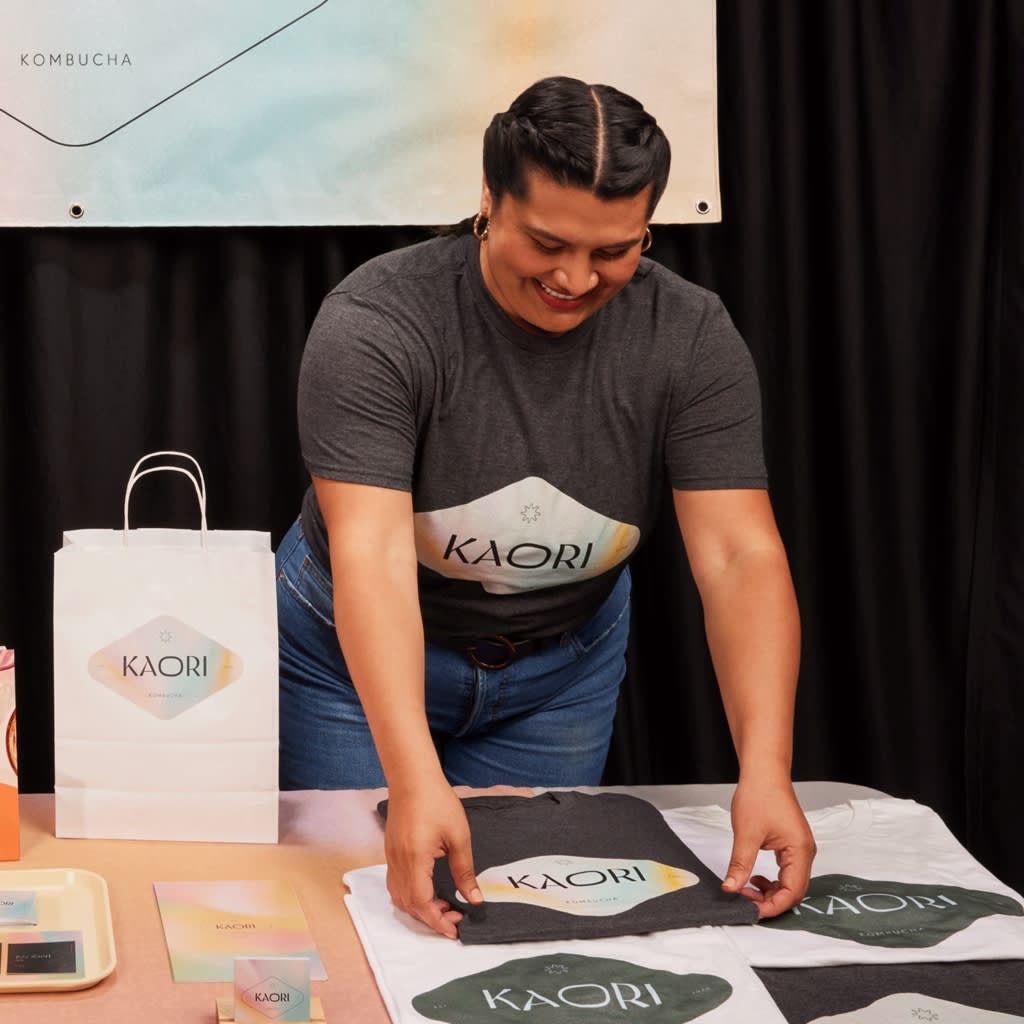 A woman working a branded stall at a business conference