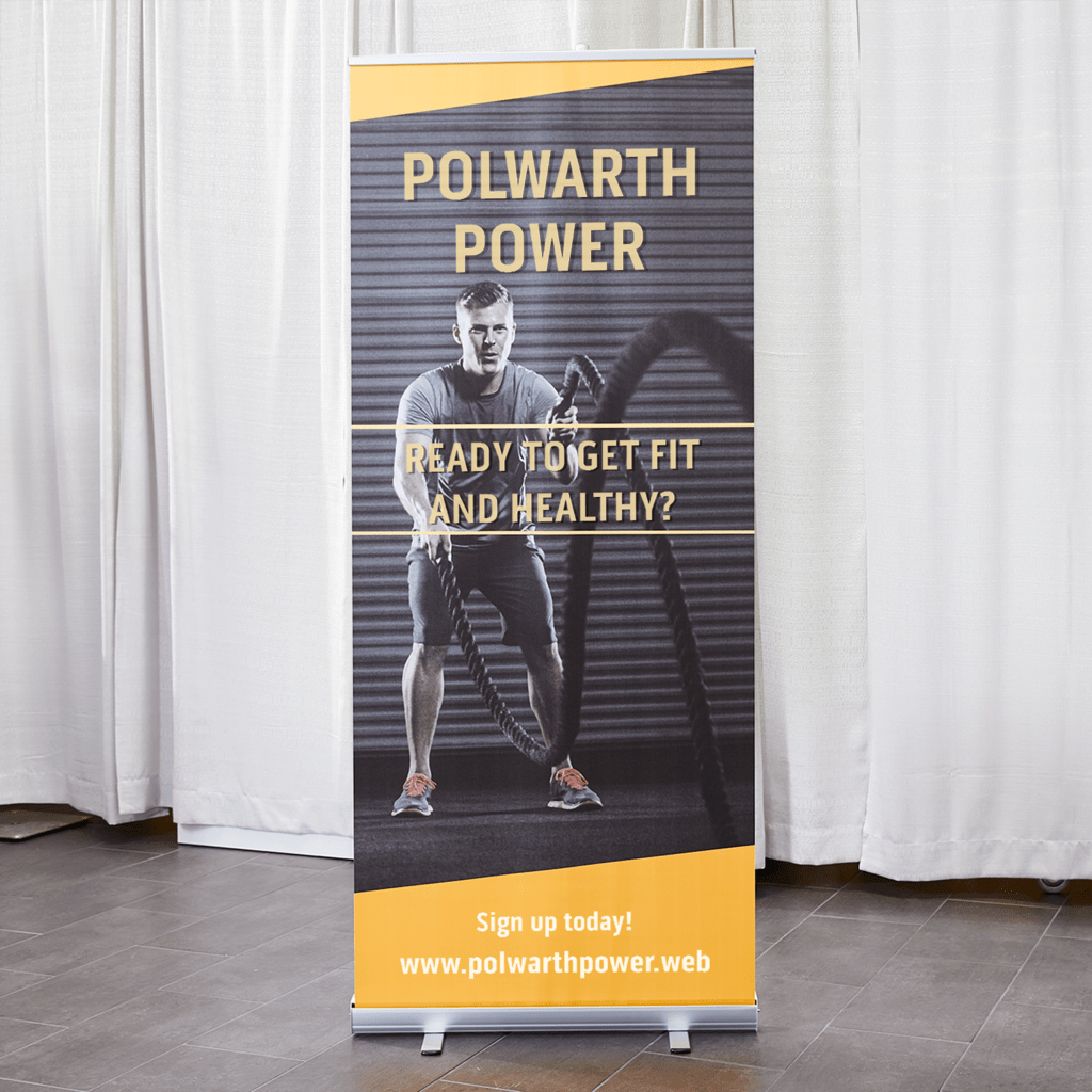 Retractable banner for a gym business with image of someone working out with a CTA to sign up today