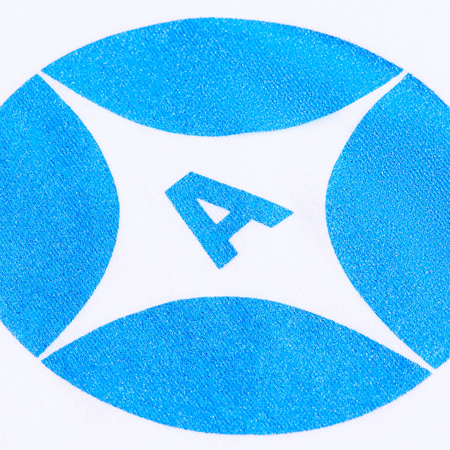 A close-up photo of a monochrome blue brand logo printed on fabric using screen printing method