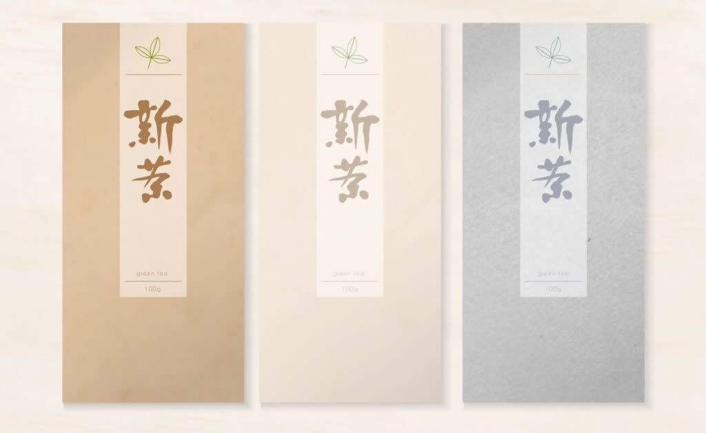 Minimalist tea packaging design with neutral-toned paper pouches in beige, cream and gray, each featuring a vertical label with simple typography and subtle botanical icon, emphasizing material texture and quiet, refined presentation.