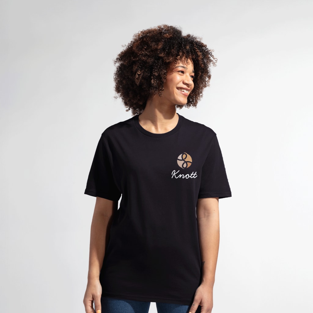 A woman wearing a black T-shirt with a left chest print